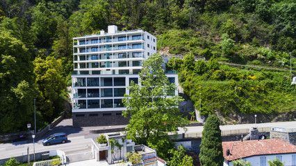 Modern house exterior with balconies and surrounded by the nature of Lake Maggiore
