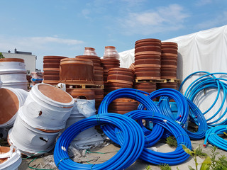A warehouse of plastic pipes for various purposes, diameter and color under the open sky. Manufacture and sale of plastic products for construction works.om plastic. Drainage and sewerage. 