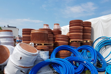 A warehouse of plastic pipes for various purposes, diameter and color under the open sky....