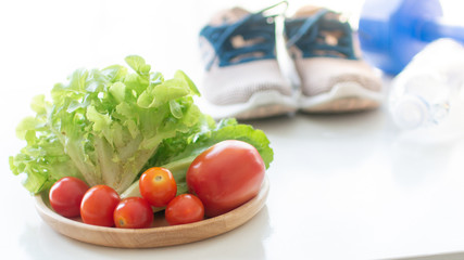 healthy concept vegetables and fruits with excercise equipment