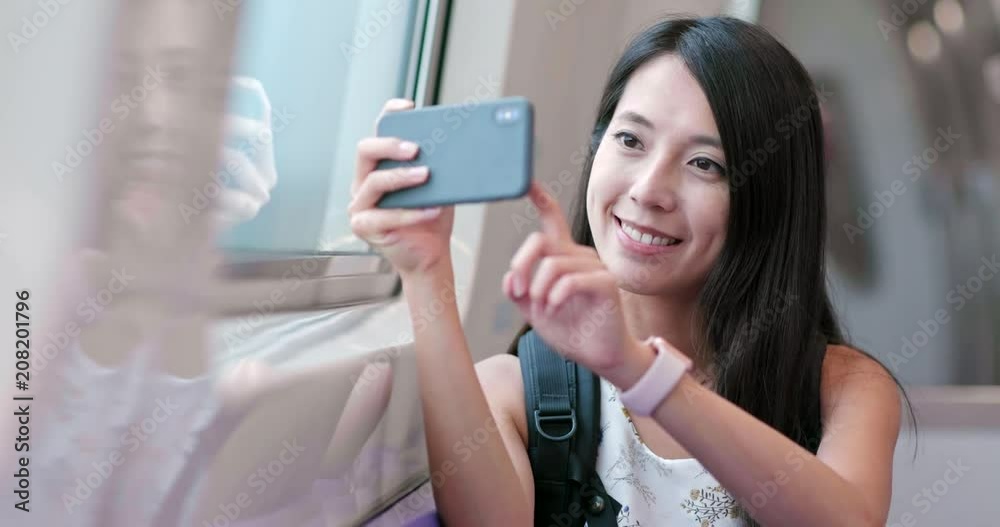 Poster travel woman taking photo on cellphone in taipei train