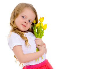 Obraz na płótnie Canvas Little girl with a bouquet of tulips.