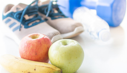 healthy concept vegetables and fruits with excercise equipment