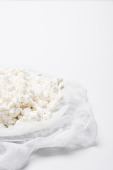 close-up shot of cottage cheese on cheesecloth on white surface