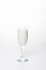 close-up shot of fresh milk in wineglass on white surface