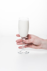 cropped shot of woman holding wineglass of milk isolated on white