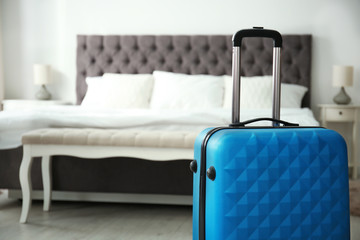Travelling bag in hotel room - obrazy, fototapety, plakaty