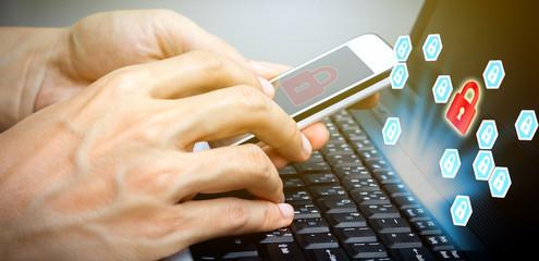 hand use smartphone and laptop with padlock technology