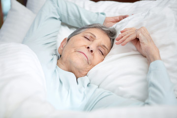 Fototapeta na wymiar Elderly woman getting a good nights rest.