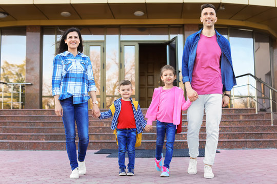 Young Parents Taking Their Little Children To School