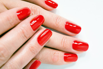 Female hands with beautiful red manicure.