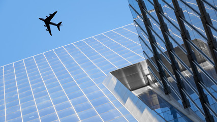 a plane flying over modern buildings of New York City