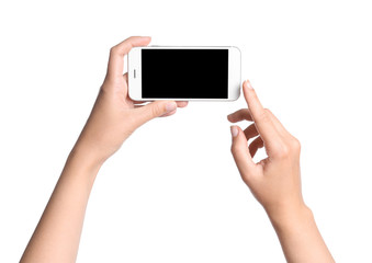 Young woman holding mobile phone with blank screen in hands on white background