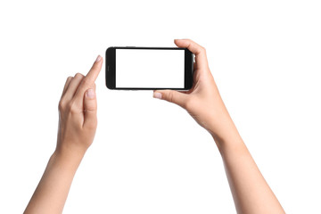 Young woman holding mobile phone with blank screen in hands on white background