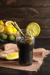 Glass with natural black lemonade on table