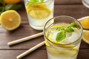 Glass with natural lemonade on table, closeup