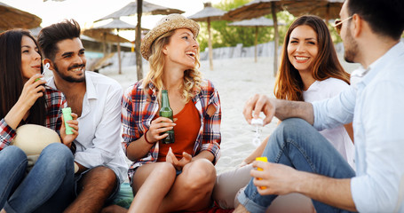Happy group of young people having fun on beach