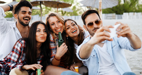 Happy young people taking selfies