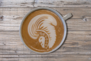 Cafe Mocha with latte art indian head design on wooden table