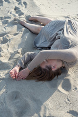 Woman lies on the sand