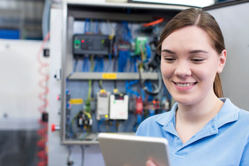Female Engineer In Factory With Digital Tablet