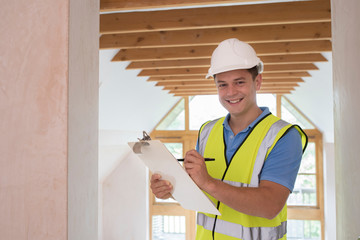 Portrait Of Building Inspector Looking At New Property