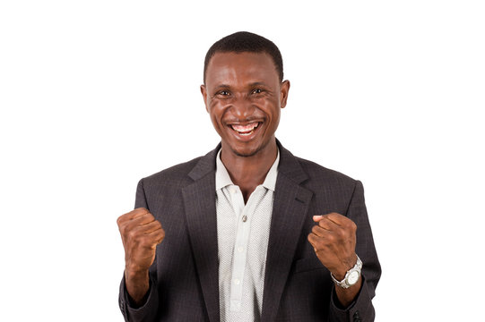 young man in a suit standing on a white background, happy.