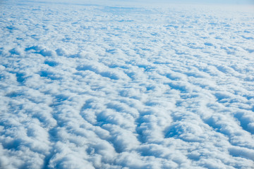 Fototapeta na wymiar clouds from airplane window. View of the sky above the clouds