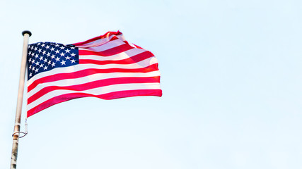 Fototapeta premium 4th of July banner with USA flag fluttering on the wind.