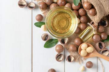 Bowl of macadamia nut oil and macadamia nuts