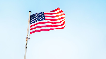 Fototapeta premium American flag fluttering on the wind. USA holidays banner.