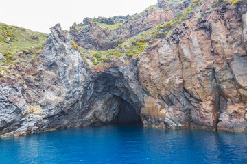 Fototapeta na wymiar Aeolian Islands in the Tyrrhenian Sea, near Sicily. Rocky, lava-formed picturesque and rough shores of the Lipari island 