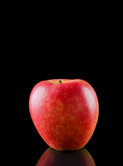 Fototapeta na wymiar Red apple on a black background with reflection / Red apple on a black background