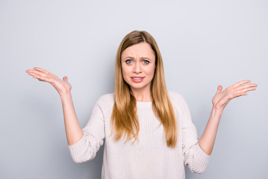 Portrait of frustrated confused girl gesturing with palms isolated on grey background conflict scandal dispute insult offense concept