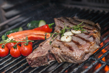 Club Steak and Grilled Vegetables Being Prepared in Josper