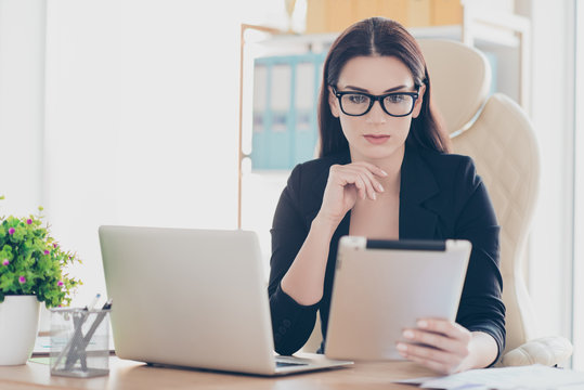 Portrait of successful attorney hardworking financier attractive smart woman in glasses using tablet wi-fi internet, teleworking concept, sitting at work place