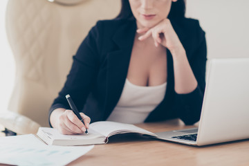 Cropped portrait of thoughtful ponder director organizing day week writing letter message date time of meeting in reminder, making list to do, sitting in workstation