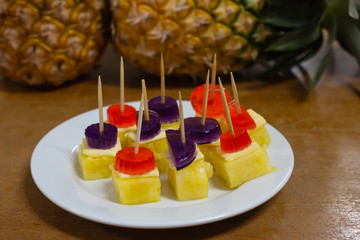 Fresh pineapple fruit with sheet and jelly on table
