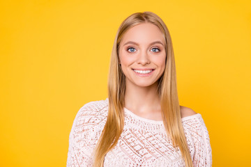 Portrait of positive nice girl in sexy outfit looking at camera isolated on yellow background