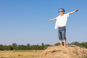 Happy little boy playing in the park at the day time.