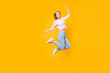 Portrait of playful crazy girl jumping in the air looking at camera enjoying weekend having perfect...