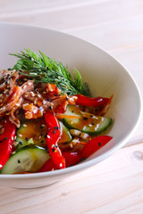 Salad with meat, bell pepper, tomato, cucumber and sesame