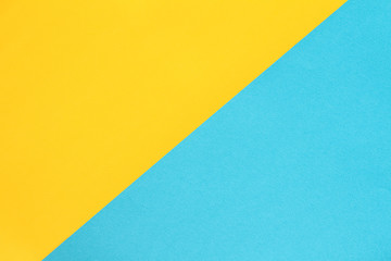Abstract asymmetrical geometric watercolor paper colorblock background in bright yellow and blue colors.