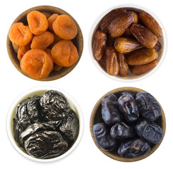 Collage of different dried fruits. Dried prunes, dried apricots and dates isolated on white background. Top view. Dried fruits isolated on a white background.