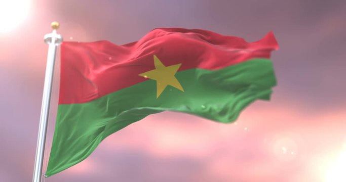 Flag of Burkina Faso waving at wind in slow at sunset, loop