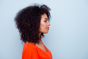 Profile portrait of charming pretty woman with modern hairdo in orange outfit isolated on grey background with copyspace empty place © deagreez