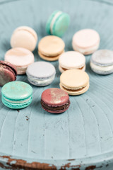 French macaroon dessert and flowers eucalyptus on a turquoise background. pastel colors