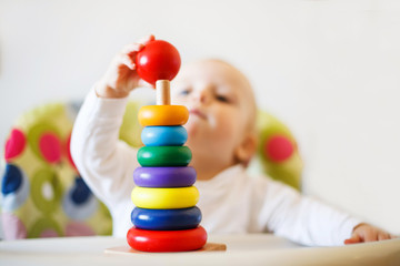 the kid plays the pyramid. child playing with wooden toys