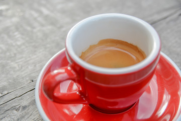 Close up of coffee red tasty espresso cup on wooden table