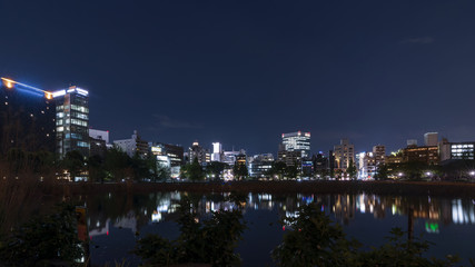 Fototapeta na wymiar Beautiful night view of the Ueno district of Tokyo, Japan, with reflection in the Shinobazuno pond